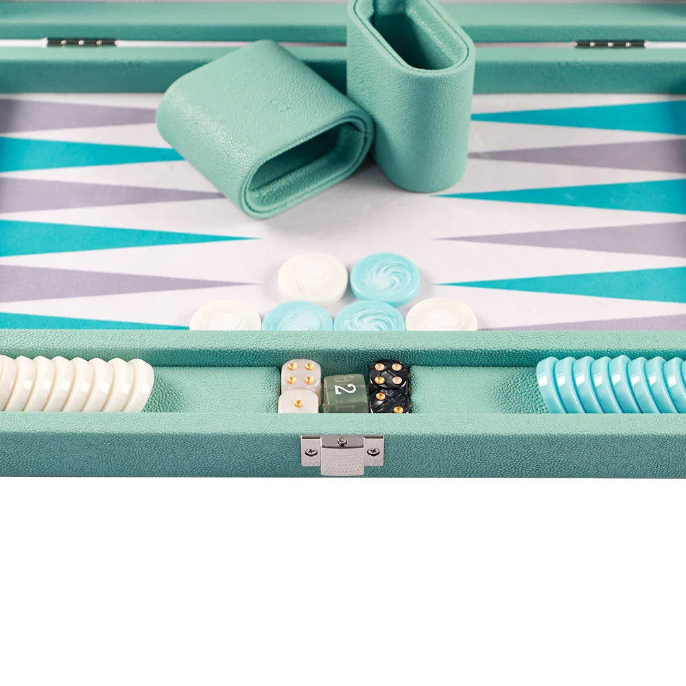 Luxury turquoise vegan leather backgammon set with matching dice, checkers, and cups on patterned board