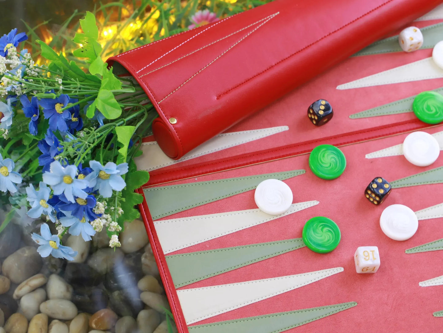 Playing backgammon on a red roll-up travel set